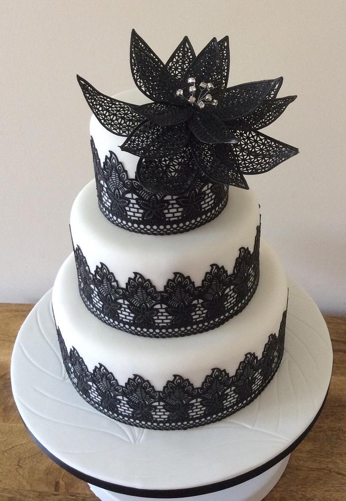 Dramatic black and white laced wedding cake
