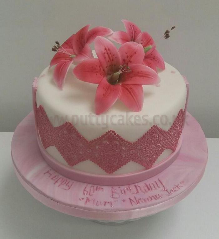 Lily cake with edible flowers and cake lace