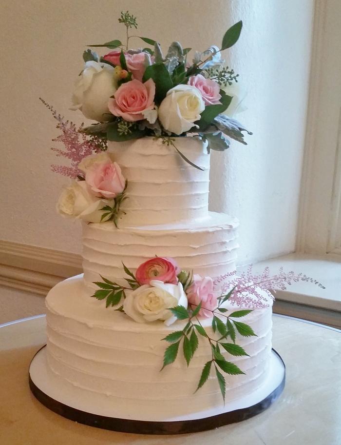 Horizontally textured buttercream wedding cake