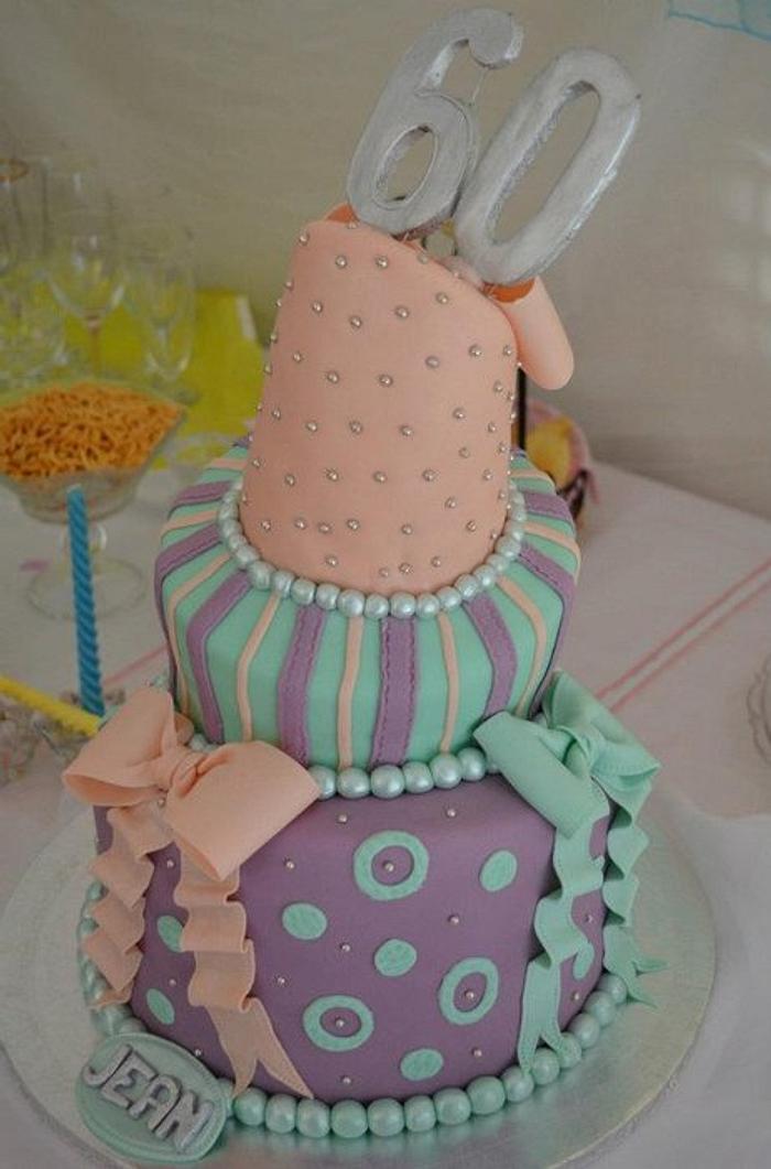 3 tier topsy turvy cake with pearls and bows.