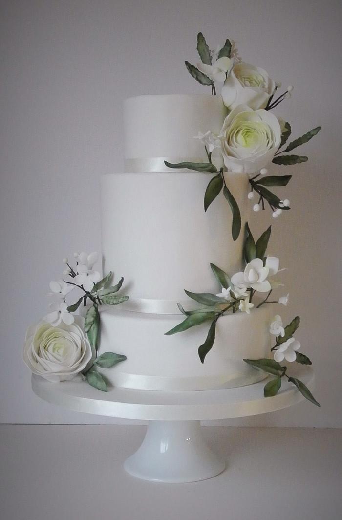 Winter whites wedding cake with ranunculus & foliage
