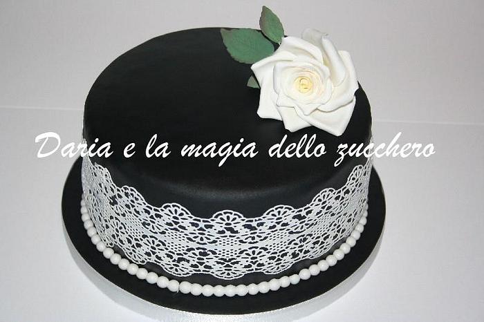 Black cake with white rose