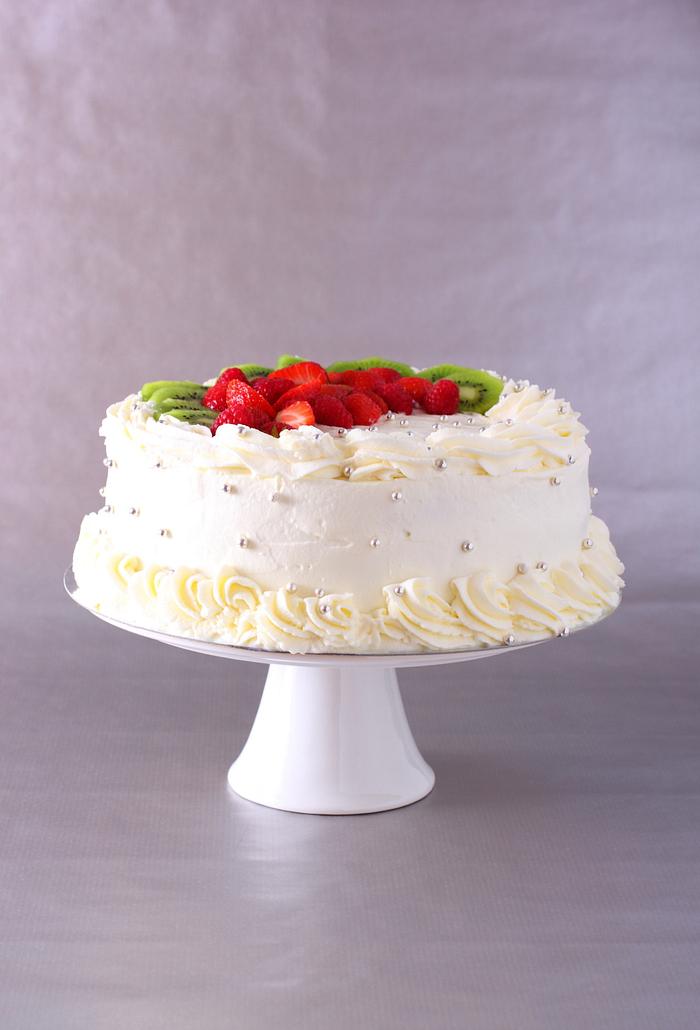 Cream fresh wedding cake with fruit and berries