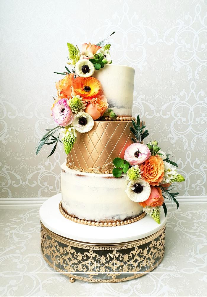 Semi naked,solid gold wedding cake dressed with fresh flowers