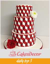 Modern red and white cake with geometric patterns.
