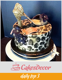 Leopard print cake with gold sparkly shoe and cupcake tower