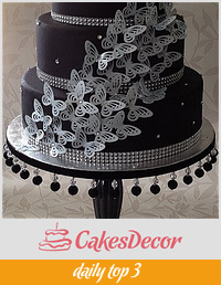 black and silver butterfly cake on homemade cake stand