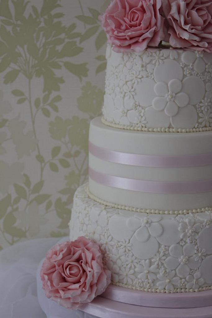 A three tier wedding cake with 2 embossed tiers and - CakesDecor
