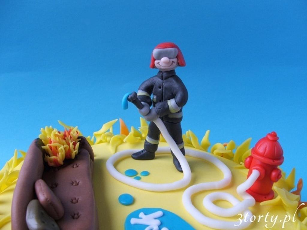 Firefighter and burning couch Cake by 3torty CakesDecor