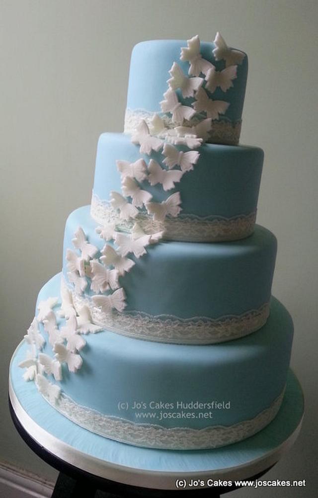 Wedgwood Blue 4 Tier Wedding Cake with Ivory Butterflies - CakesDecor