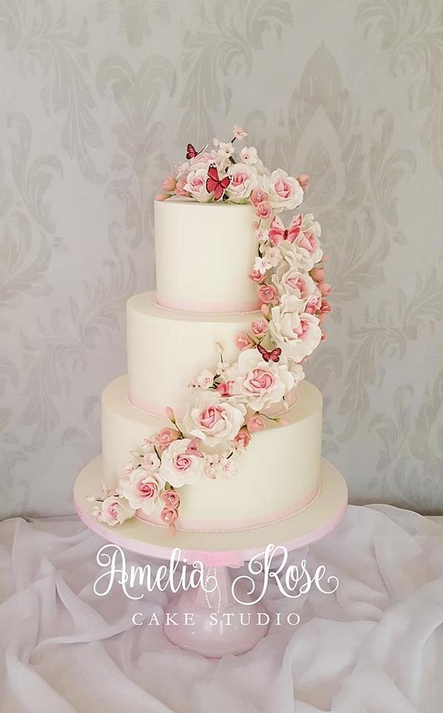 Pink rose and butterfly cascade wedding cake