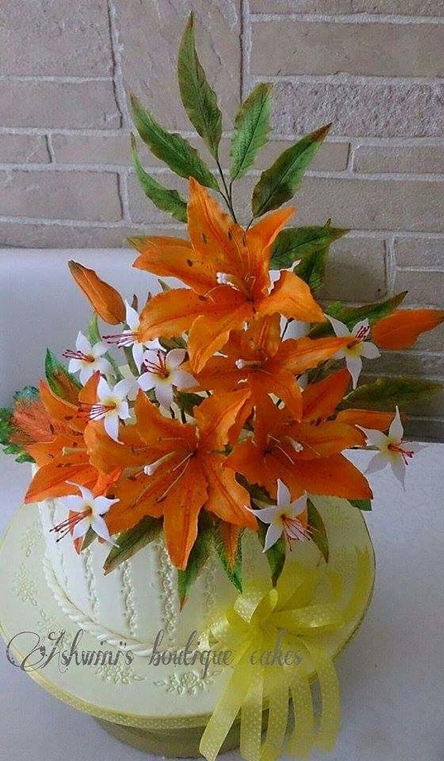 Burnt Orange Lilies - Decorated Cake by Ashwini Tupe - CakesDecor