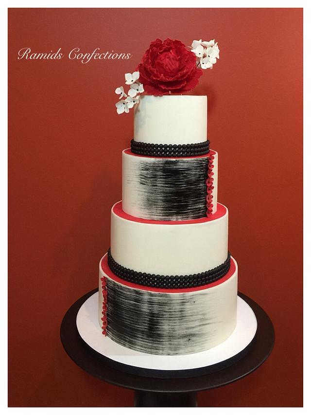 A 3-tier black and white cake with fondant flowers - Today's Bride