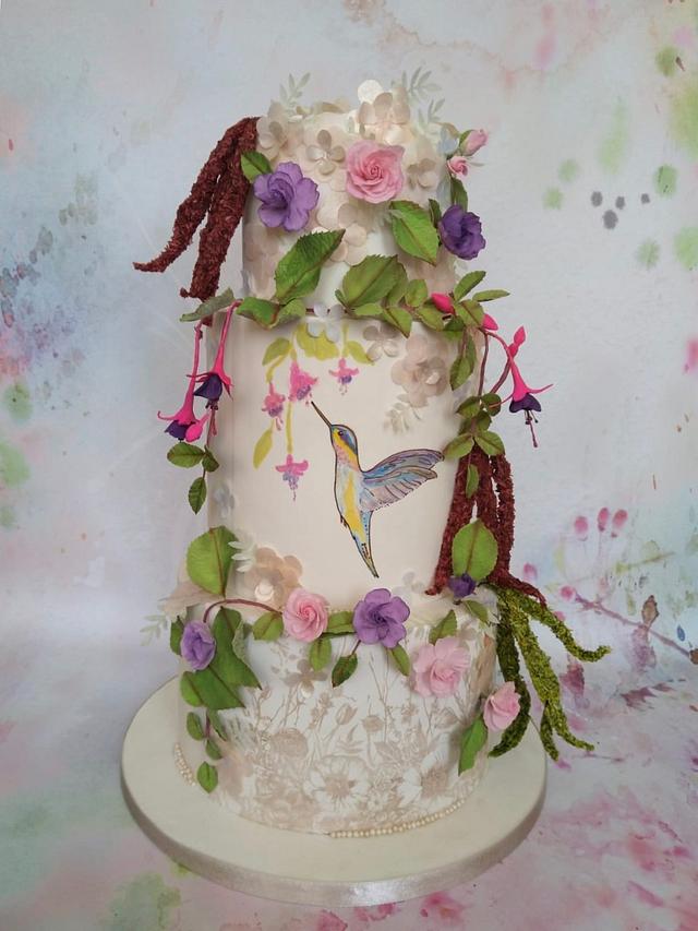 A humming bird in the enchanted garden - Decorated Cake - CakesDecor