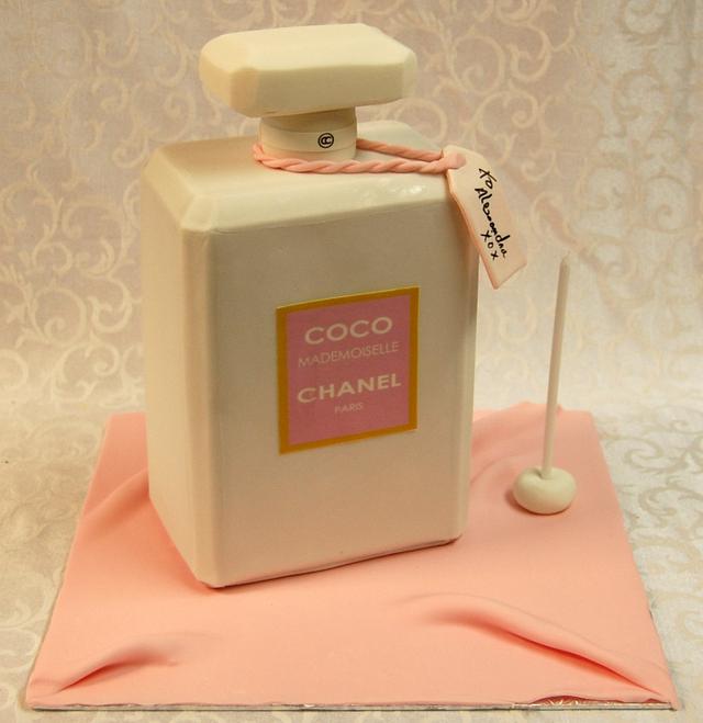 Classy black and gold Chanel cake with perfume bottle.