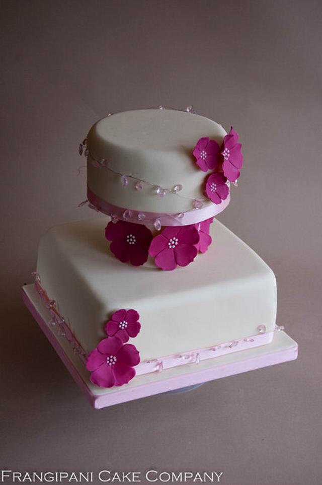 Three tiered ivory wedding cake with flowers - Decorated - CakesDecor