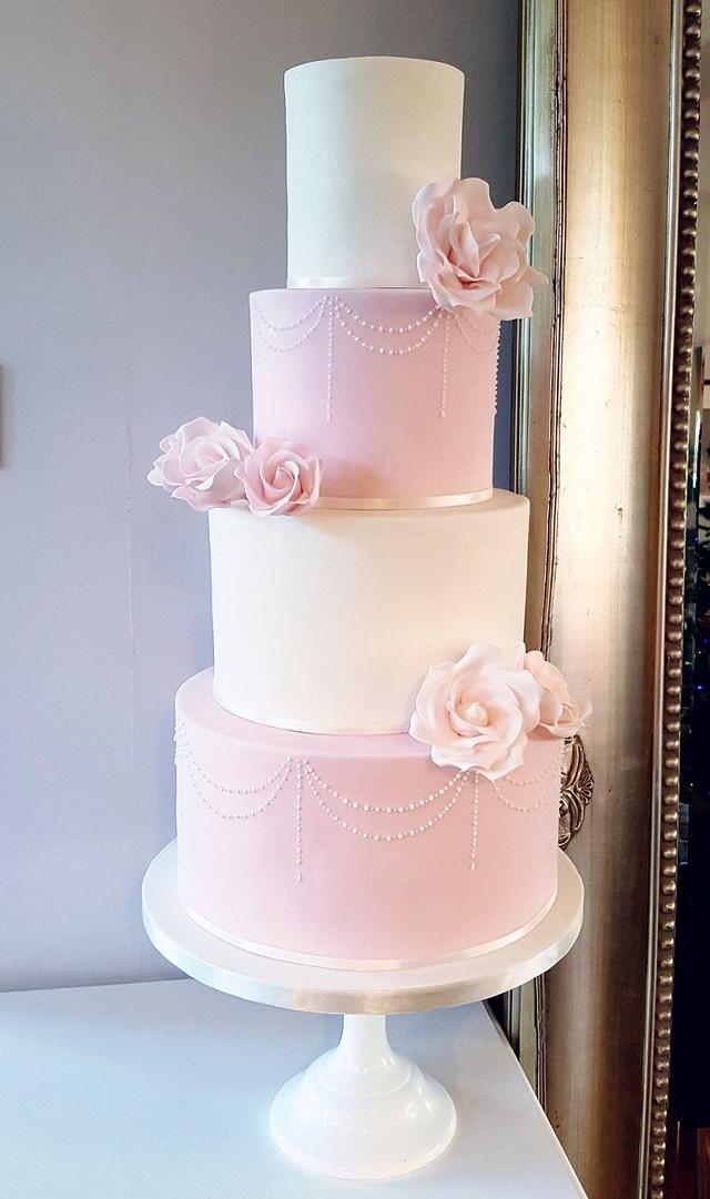 Blush pink and ivory rose wedding cake