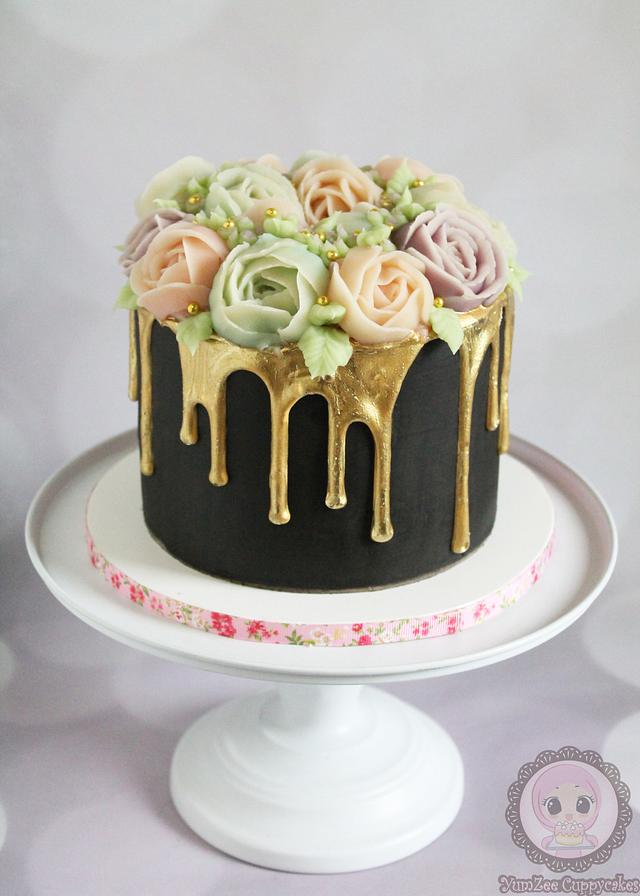 Gold drip cake with piped flowers