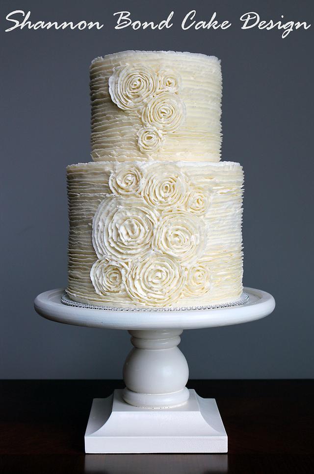 3 tier wedding cake with buttercream ruffles and edible flowers. On white  background. Stock Photo | Adobe Stock