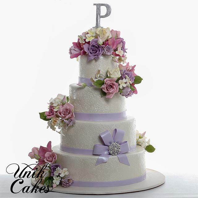 Flowers and stencilled lace wedding cake