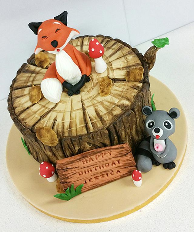 Fox on a tree stump and raccoon birthday cake