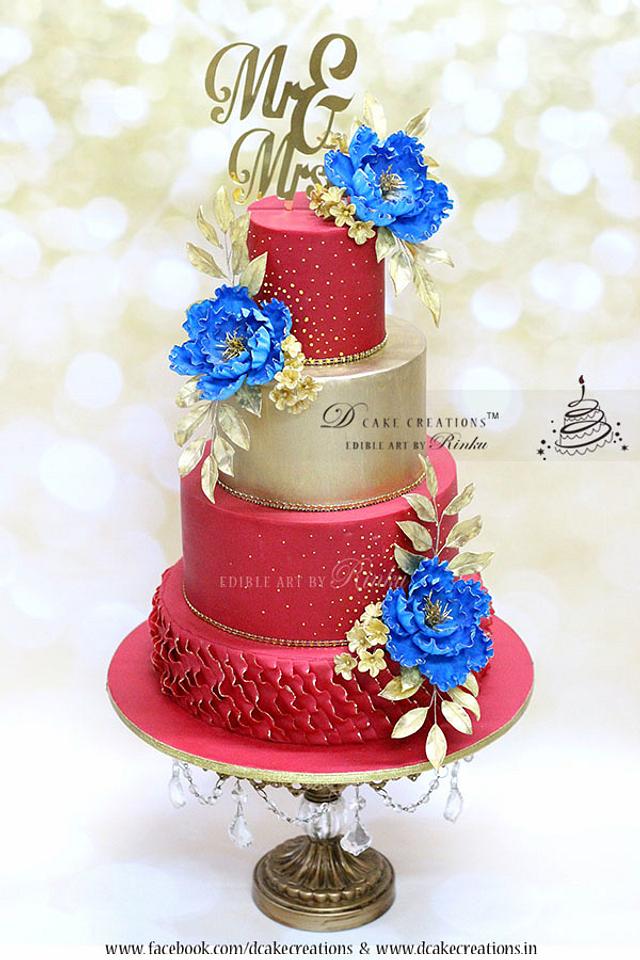Red & Gold Wedding Cake with Royal Blue Flowers
