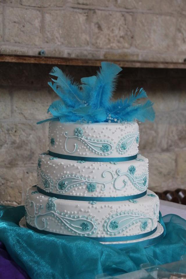 Blue/ Teal Paisley wedding cake with feather and crystal topper