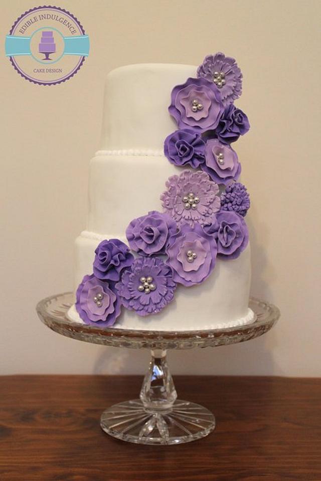 Colorful Wedding Cream Cake With Lovely Purple Flowers Adorn The Top And  Blueberries Stock Photo, Picture and Royalty Free Image. Image 74916219.