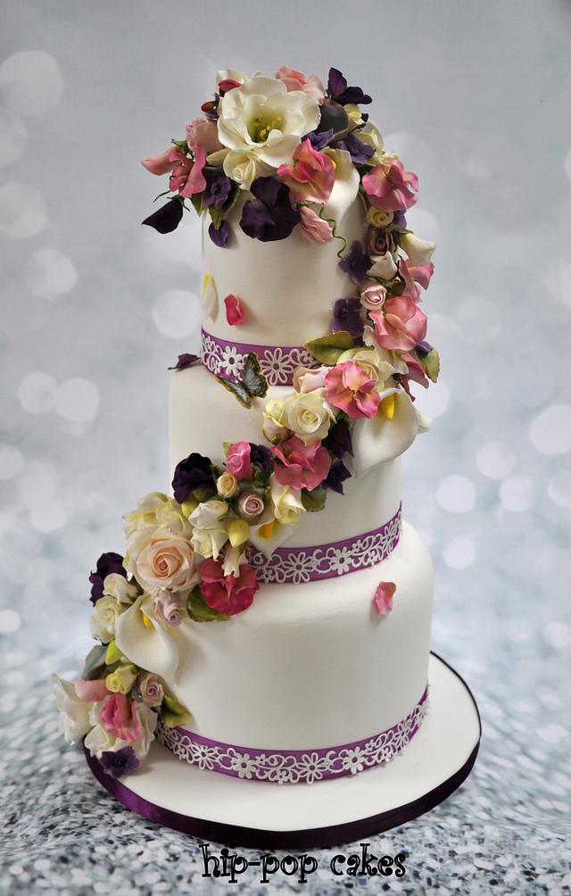 cascading flowers wedding cake Decorated Cake by Lesley CakesDecor