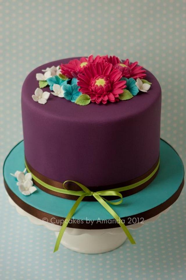 Purple, Teal & Pink Gerbera Cake - Decorated Cake by - CakesDecor