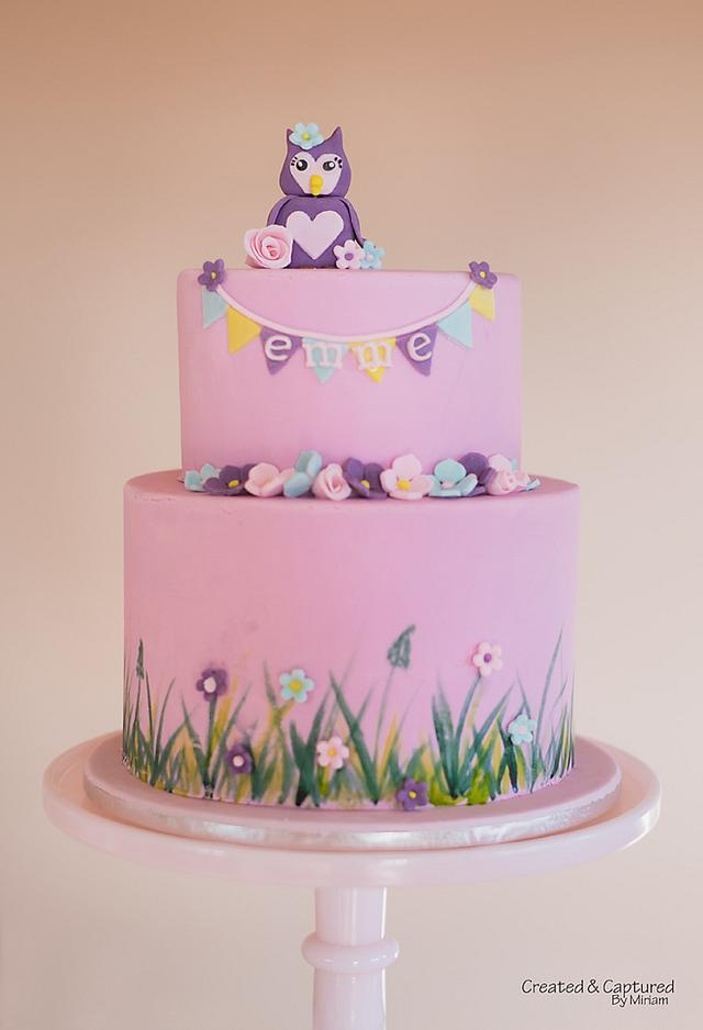 Purple and pink owl on branch on half sheet cake framed in rose buds