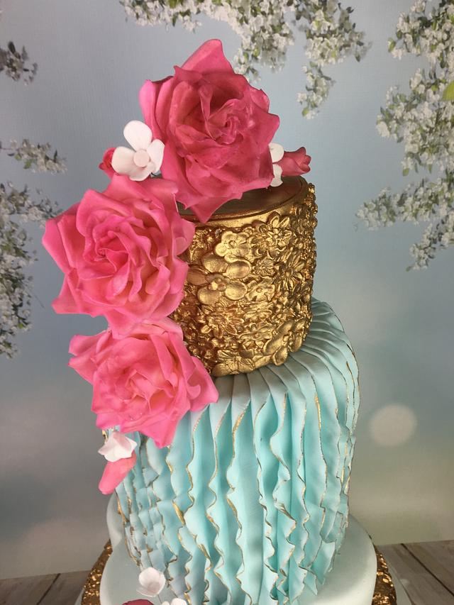 Vertical ruffles, pink roses and gold  wedding cake 