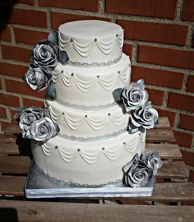 White wedding cake with silver roses