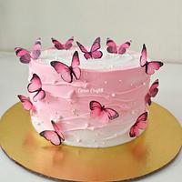 Whipped cream cake with waves pattern and edible butterflies