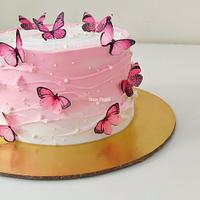 Whipped cream cake with waves pattern and edible butterflies