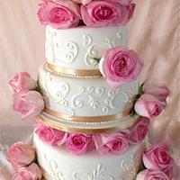 Ivory wedding cake with blush pink roses
