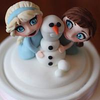 Frozen themed cake with baby Elsa, baby Anna, Kristoff, Hans, Olaf and Sven!