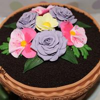 A Terracotta Flower Pot Cake with handmade Roses and Pansies completed with a handmade trowel 