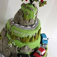 Hillside with boy racer cars - Cake by Zoe's Fancy Cakes - CakesDecor