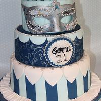 A Three Tier Masquerade ball cake topped with a handmade and handpainted Mask