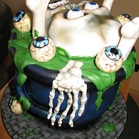skull cake  in cauldron cake and cake pops eyes