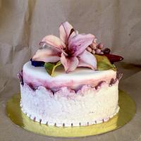 Purple cake with lily and roses.