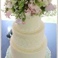 Wedding cake with lace and real flowers....