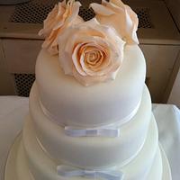 Four Tier Ivory Bow wedding cake with Peach Roses