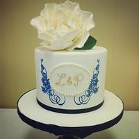 Hand painted cake in royal blue, gold monogram & white sugar rose 