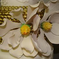Magnolia and gold wedding cake