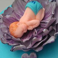 Baby asleep in a flower Cake