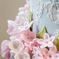 Duck egg blue lace wedding cake with pink sugar flowers