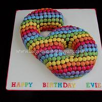 Colourful rainbow number 6 cake