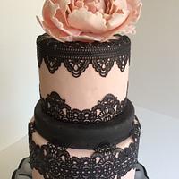 pink fondant cake with black lace
